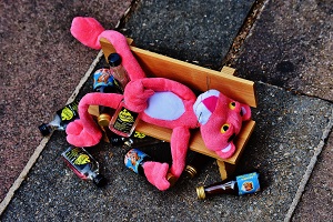 stuffed animal lying with empty bottles