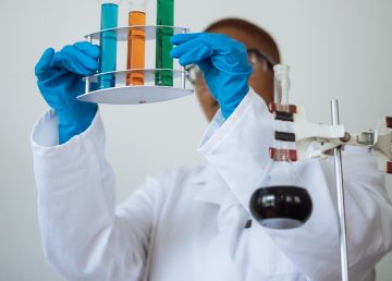 scientist holding vials