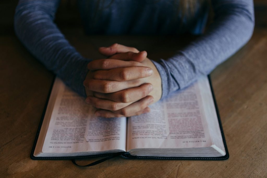 praying hands on book