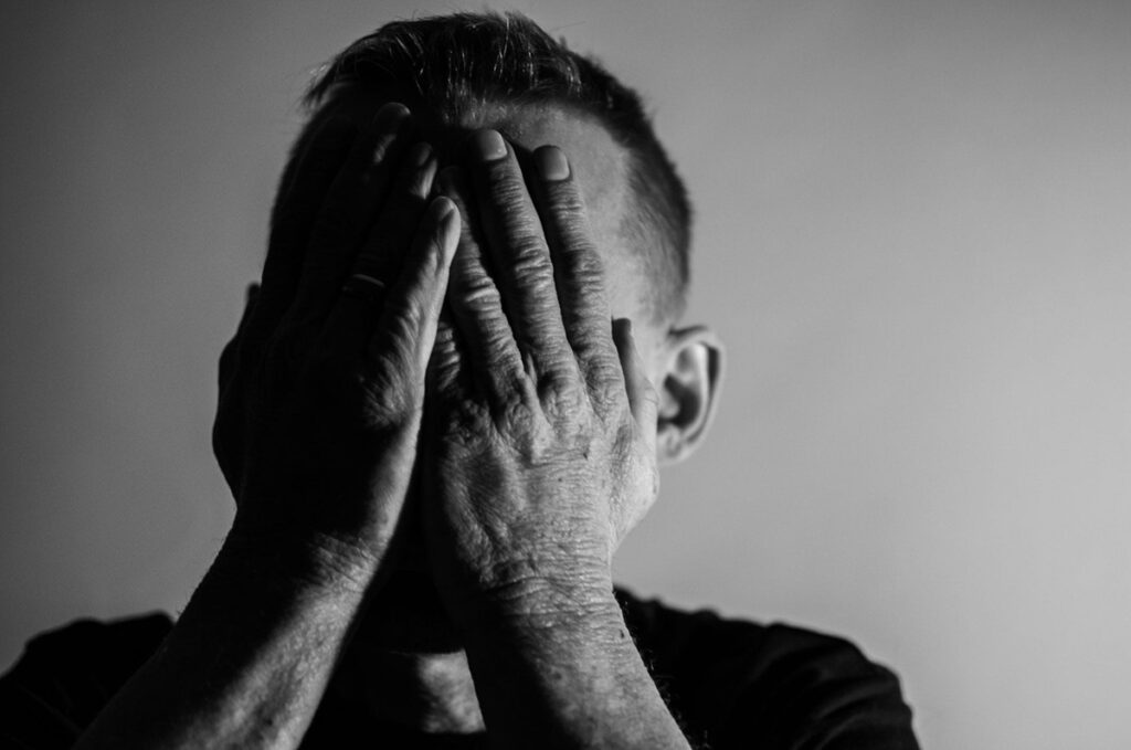 Man holding his face in his hands