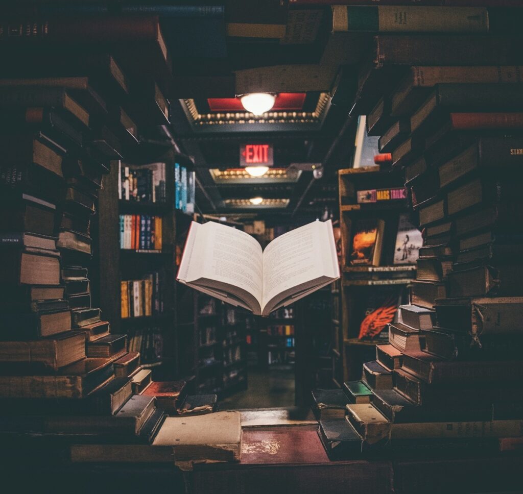 view-of-floating-open-book-from-stacked-books-in-library