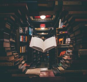 view-of-floating-open-book-from-stacked-books-in-library