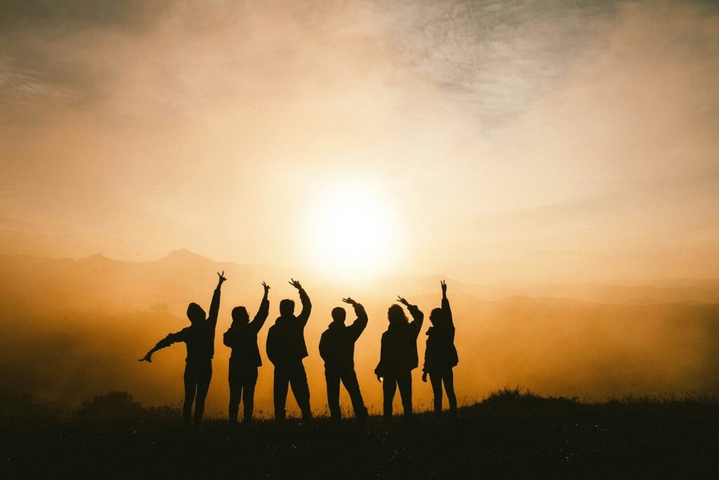 people gesturing in the wilderness