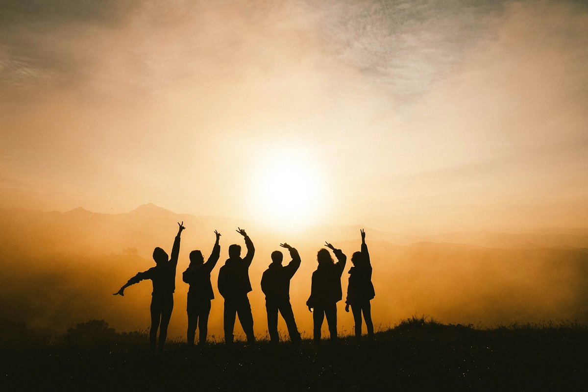 people gesturing in the wilderness