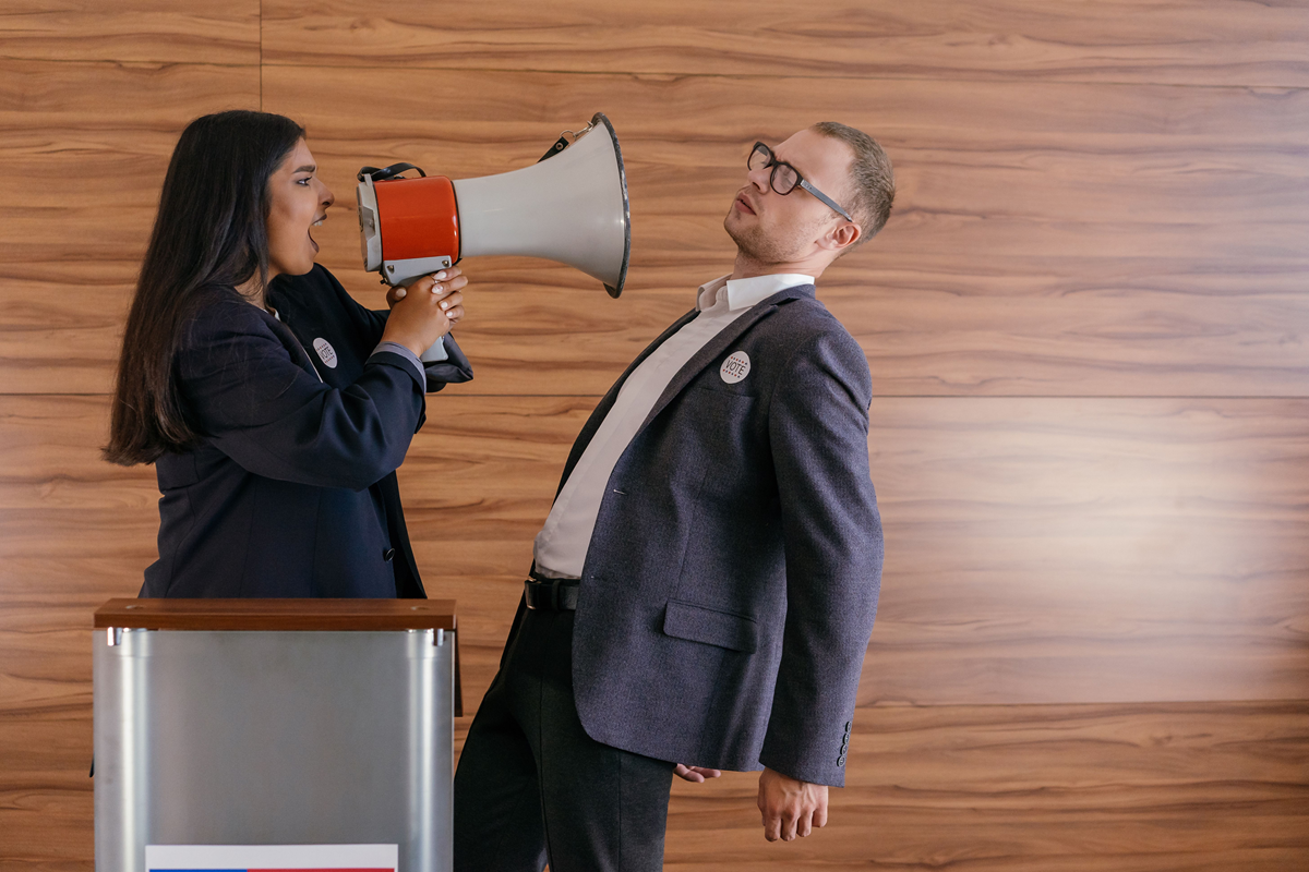 woman shouting at man with megaphone